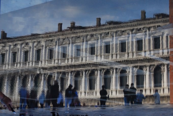Reflections in the water in St. Mark's Square, Venice, Italy