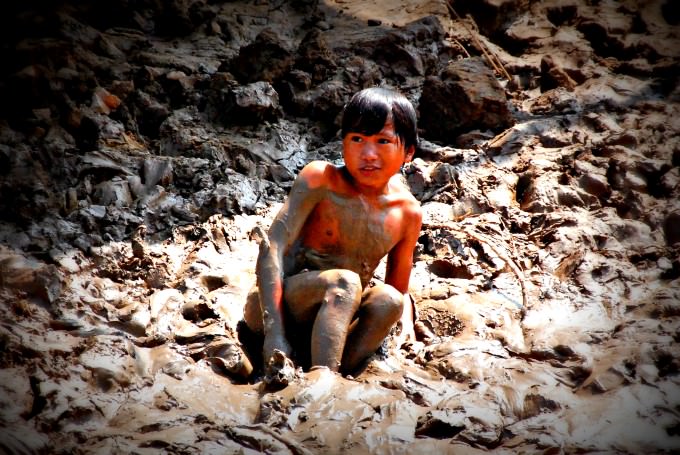 Cambodian Village Boy Plays in the Mud