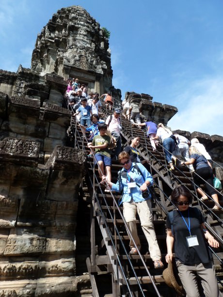 Slow going on steps leading to a tower at Angkor Wat
